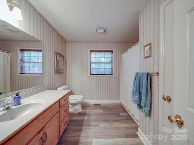 4620 Binwhe Ln, Gastonia, NC 28052 - full bath with wallpapered walls, vanity, toilet, wood finished floors, and a textured ceiling