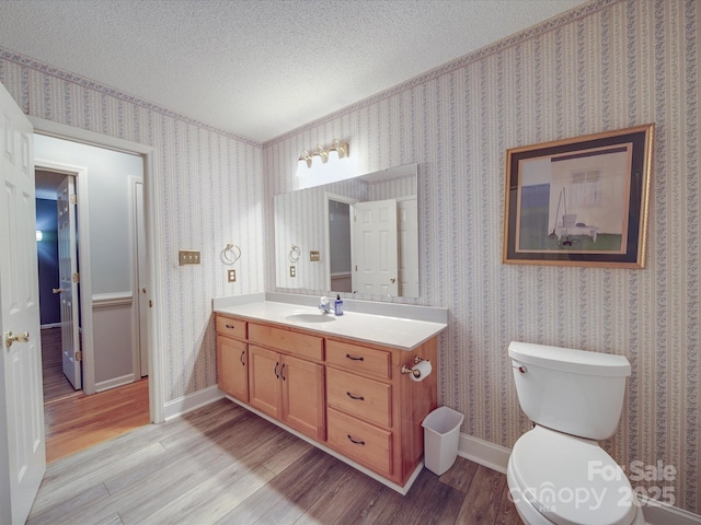 4620 Binwhe Ln, Gastonia, NC 28052 - half bathroom with wood finished floors, vanity, toilet, wallpapered walls, and a textured ceiling
