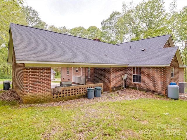 4620 Binwhe Ln, Gastonia, NC 28052 - rear view of house featuring a shingled roof, brick siding, and a lawn