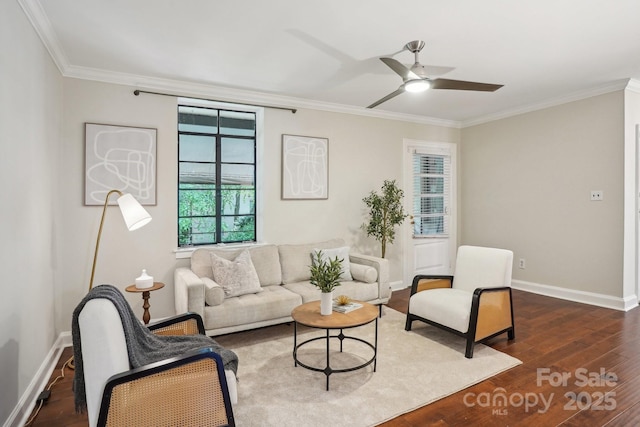 living area featuring ornamental molding, dark wood-style flooring, baseboards, and ceiling fan