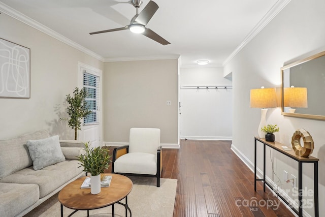 living room with crown molding, dark wood-type flooring, ceiling fan, and baseboards