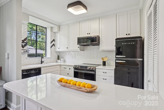 kitchen with black appliances, a sink, light countertops, and backsplash