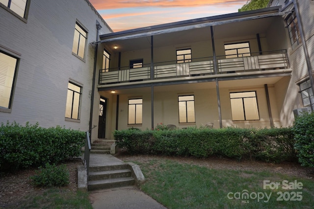 view of front of house featuring a balcony
