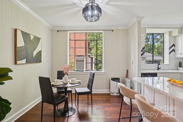 dining space with baseboards, dark wood-type flooring, healthy amount of natural light, crown molding, and cooling unit
