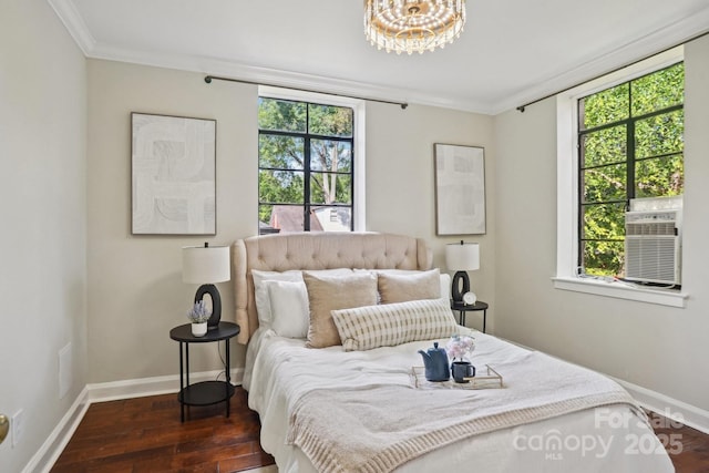 bedroom with crown molding, wood finished floors, baseboards, cooling unit, and a chandelier