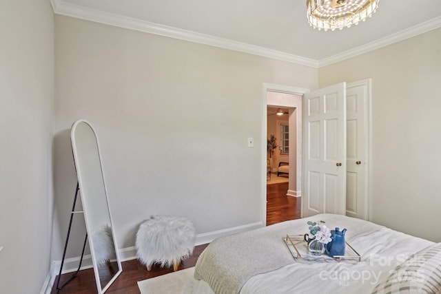 bedroom with crown molding, baseboards, and dark wood finished floors