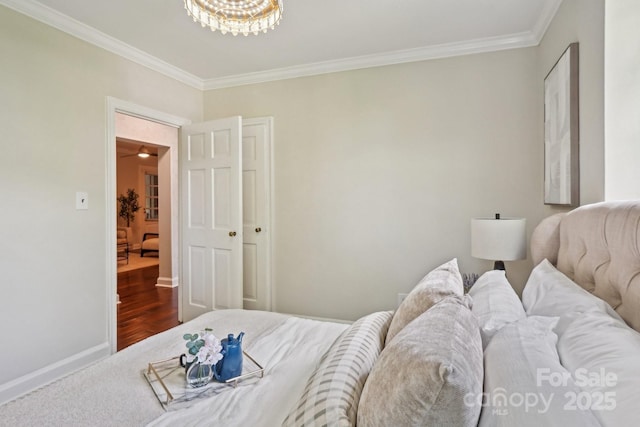 bedroom with ornamental molding, a chandelier, wood finished floors, and baseboards