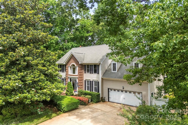 4846 Deer Cross Trl, Charlotte, NC 28269 - view of front of home featuring concrete driveway, a garage, roof with shingles, and fence