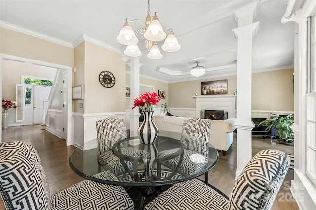 4846 Deer Cross Trl, Charlotte, NC 28269 - dining area featuring wood finished floors, a warm lit fireplace, ornamental molding, a chandelier, and a decorative wall