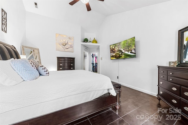 4846 Deer Cross Trl, Charlotte, NC 28269 - bedroom featuring dark tile patterned floors, vaulted ceiling, ceiling fan, baseboards, and a spacious closet