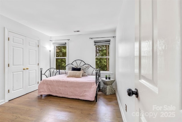 4846 Deer Cross Trl, Charlotte, NC 28269 - bedroom with multiple windows, wood finished floors, and baseboards