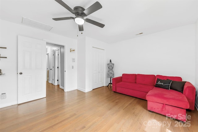 4846 Deer Cross Trl, Charlotte, NC 28269 - living area featuring wood finished floors, a ceiling fan, and baseboards