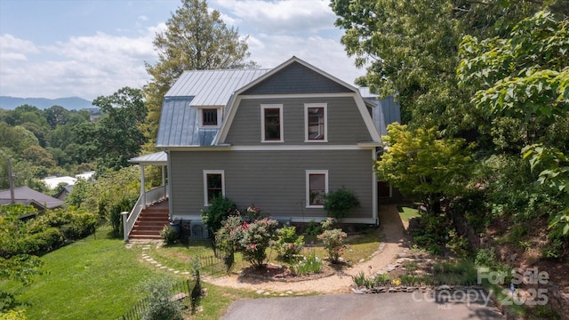 31 Jefferson Dr, Asheville, NC 28801 - rear view of property with a gambrel roof, metal roof, a lawn, stairway, and central AC unit
