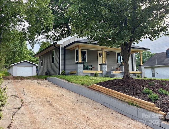 85 Archer St, Granite Falls, NC 28630 - view of front facade featuring concrete driveway, an outbuilding, covered porch, and a detached garage