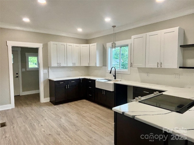 85 Archer St, Granite Falls, NC 28630 - kitchen with a sink, open shelves, dark cabinetry, light countertops, and white cabinetry