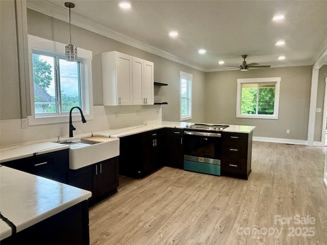 85 Archer St, Granite Falls, NC 28630 - kitchen featuring electric stove, crown molding, a peninsula, light countertops, and white cabinets