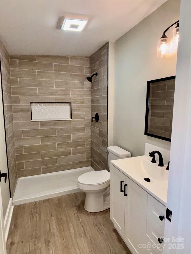 85 Archer St, Granite Falls, NC 28630 - full bathroom with wood finished floors, vanity, toilet, and a tile shower