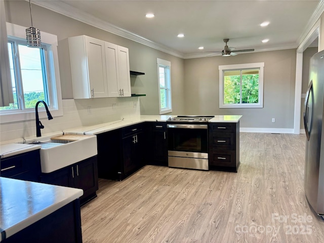 85 Archer St, Granite Falls, NC 28630 - kitchen featuring stainless steel appliances, dark cabinets, light countertops, white cabinets, and crown molding