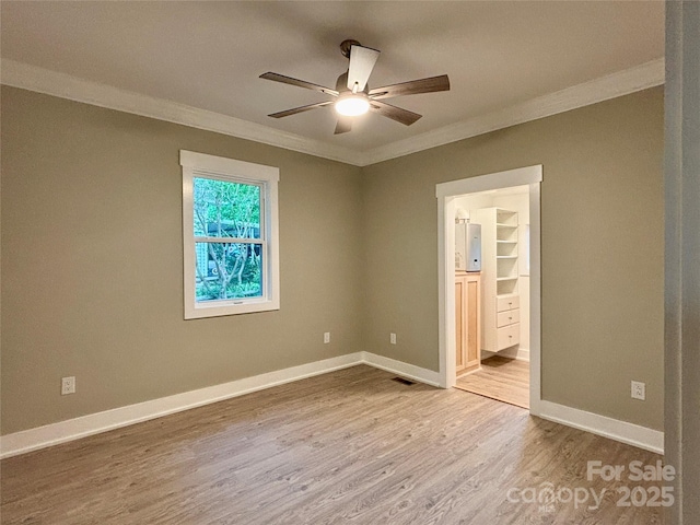 85 Archer St, Granite Falls, NC 28630 - unfurnished bedroom with crown molding, wood finished floors, connected bathroom, and a ceiling fan