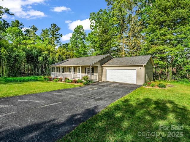 77 Simmons Dr, East Flat Rock, NC 28726 - ranch-style house featuring covered porch, a front yard, a garage, and asphalt driveway