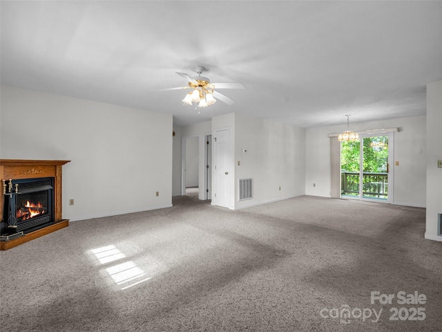 77 Simmons Dr, East Flat Rock, NC 28726 - unfurnished living room featuring a warm lit fireplace, carpet, a ceiling fan, and a chandelier