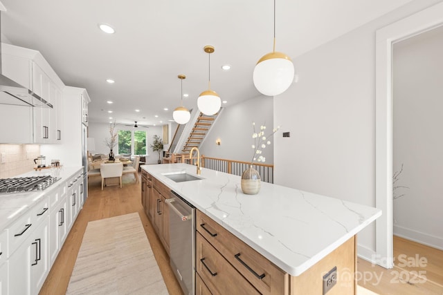 158 Mattoon St, Charlotte, NC 28216 - kitchen with stainless steel appliances, a sink, light wood-style flooring, wall chimney range hood, and a large island