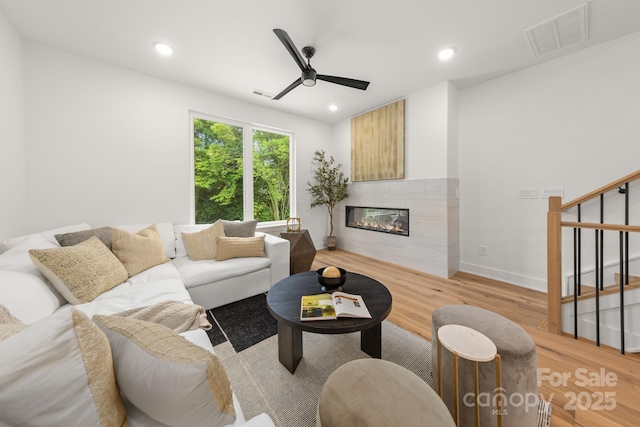 158 Mattoon St, Charlotte, NC 28216 - living area with stairway, light wood-style floors, ceiling fan, a glass covered fireplace, and recessed lighting
