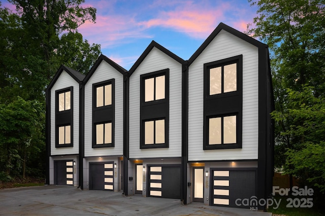 158 Mattoon St, Charlotte, NC 28216 - view of front facade with an attached garage and driveway
