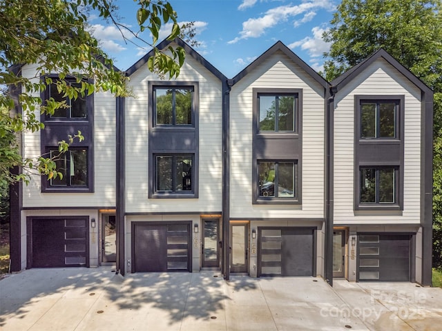 158 Mattoon St, Charlotte, NC 28216 - view of front facade featuring driveway and a garage