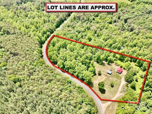 aerial overview of property's location with property boundaries highlighted and a forest
