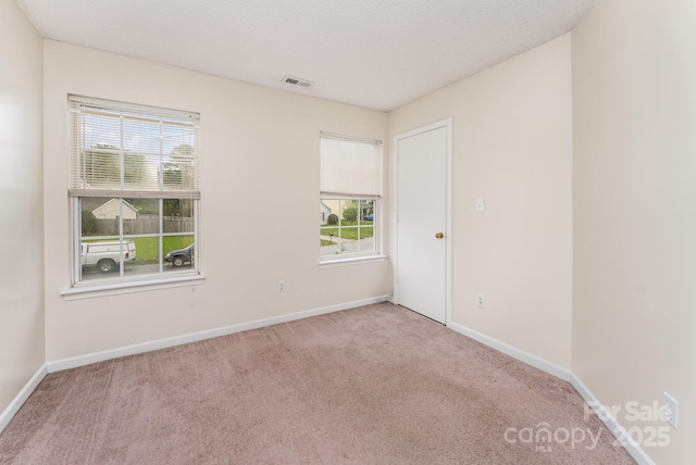 empty room with carpet flooring and baseboards