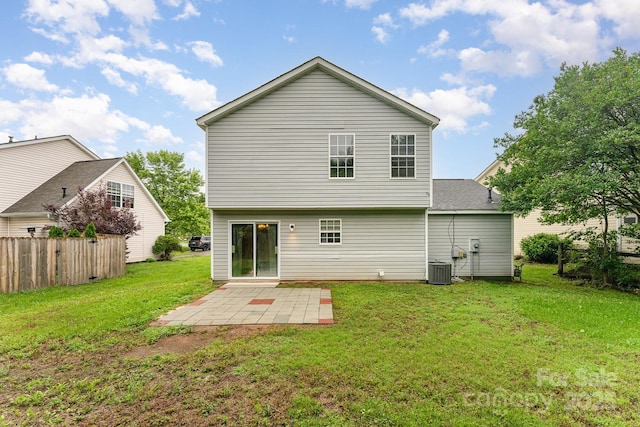 back of property with a patio area, central AC unit, and roof with shingles