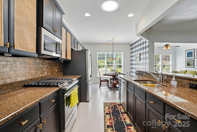 43041 Mimosa Ct, Fort Mill, SC 29707 - kitchen with stainless steel appliances, a sink, crown molding, decorative backsplash, and stone counters