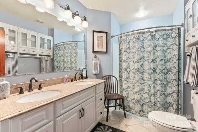 20 Deva Gln, Asheville, NC 28804 - bathroom featuring toilet, double vanity, tile patterned flooring, and a shower with curtain