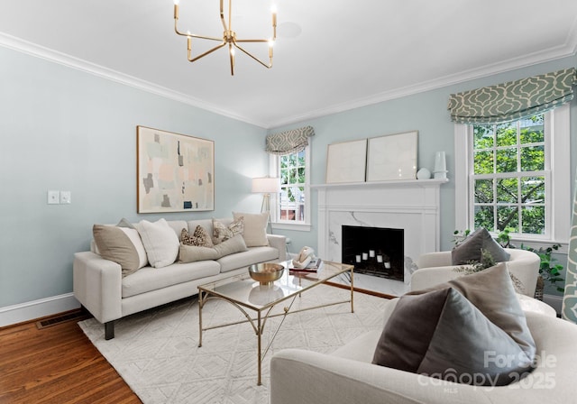 236 Wales Ave, Charlotte, NC 28209 - living area with ornamental molding, a chandelier, wood finished floors, baseboards, and a premium fireplace