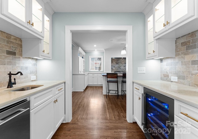 236 Wales Ave, Charlotte, NC 28209 - kitchen featuring beverage cooler, stainless steel dishwasher, a sink, decorative backsplash, and white cabinetry