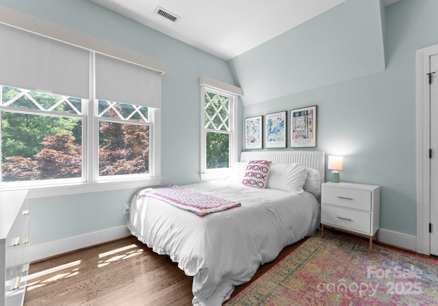 236 Wales Ave, Charlotte, NC 28209 - bedroom with baseboards, wood finished floors, and vaulted ceiling