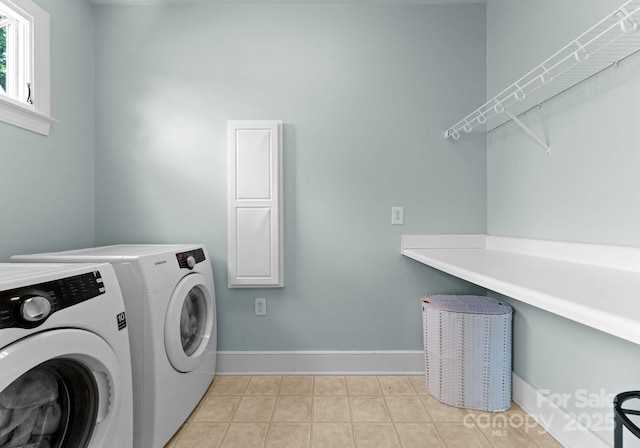 236 Wales Ave, Charlotte, NC 28209 - washroom featuring washer and dryer, baseboards, and light tile patterned floors