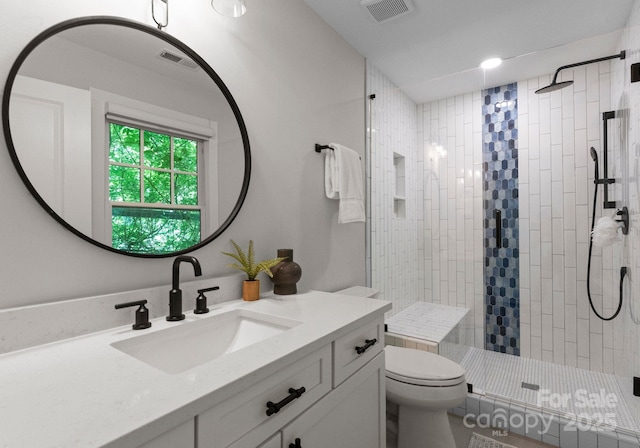 236 Wales Ave, Charlotte, NC 28209 - bathroom featuring vanity, tiled shower, and toilet