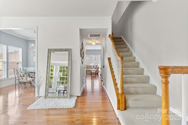 9775 Mallard Glen Dr, Charlotte, NC 28262 - foyer entrance with stairs, wood finished floors, baseboards, and crown molding