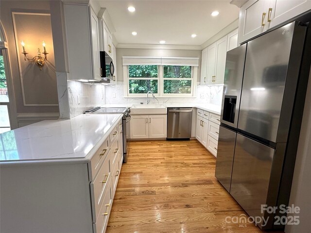 456 Brook Valley Ct NE, Concord, NC 28025 - kitchen featuring appliances with stainless steel finishes, a sink, light countertops, light wood-type flooring, and recessed lighting