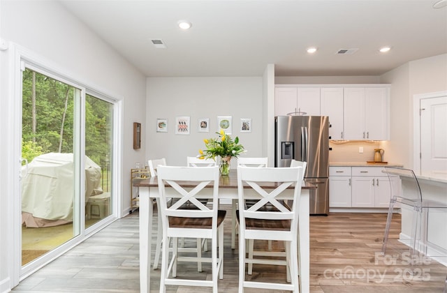 941 Rachel Anne Dr, Belmont, NC 28012 - kitchen featuring stainless steel fridge, light wood-type flooring, white cabinetry, light countertops, and recessed lighting