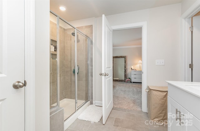 941 Rachel Anne Dr, Belmont, NC 28012 - bathroom with a shower stall, tile patterned flooring, crown molding, vanity, and recessed lighting