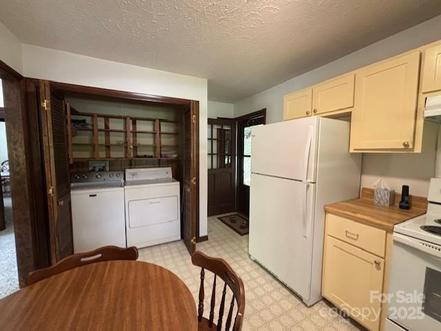 45 Old Cove Rd, Sylva, NC 28779 - kitchen featuring white appliances, light flooring, washer and clothes dryer, a textured ceiling, and under cabinet range hood