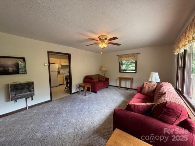 45 Old Cove Rd, Sylva, NC 28779 - living area with heating unit, carpet, a ceiling fan, a textured ceiling, and baseboards