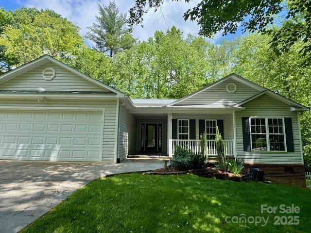 117 N River Glen Dr, Morganton, NC 28655 - ranch-style home with a porch, driveway, an attached garage, and a front yard