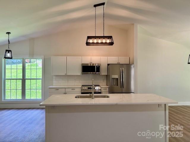 117 N River Glen Dr, Morganton, NC 28655 - kitchen with stainless steel appliances, lofted ceiling, a sink, white cabinets, and tasteful backsplash