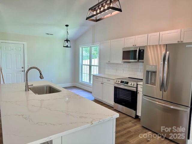 117 N River Glen Dr, Morganton, NC 28655 - kitchen featuring stainless steel appliances, a sink, wood finished floors, tasteful backsplash, and white cabinetry