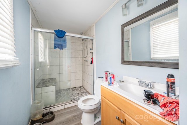 full bath featuring a shower stall, toilet, plenty of natural light, and wood finished floors