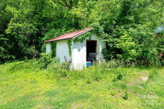 view of shed featuring a view of trees